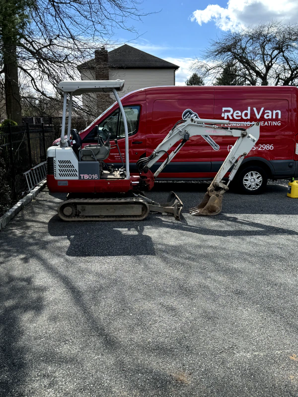 Red Van service vehicle with excavation equipment for sewer line work