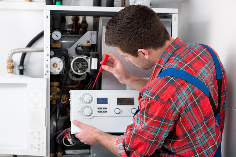 Technician servicing a residential boiler