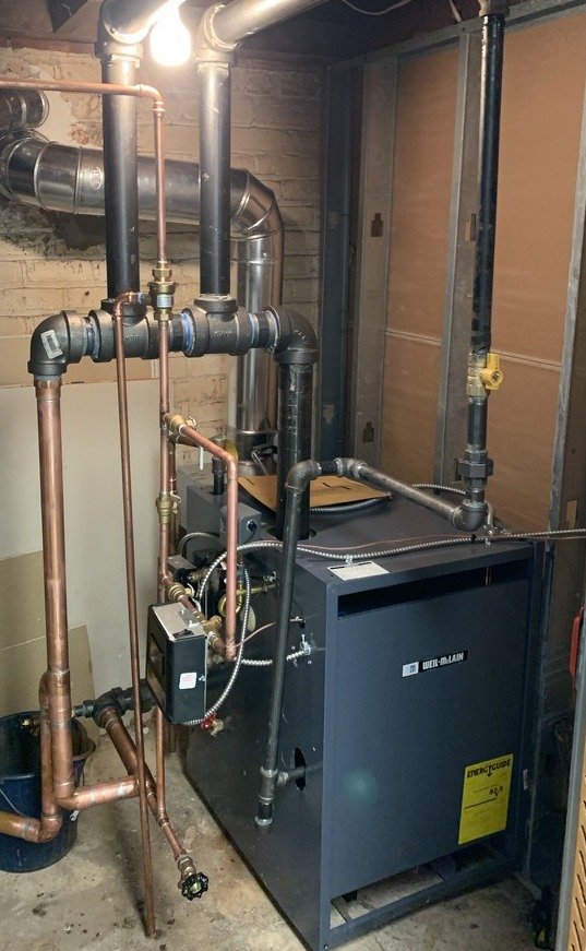 New Weil-McLain steam boiler with clean near-boiler piping installed in a Bergen County home